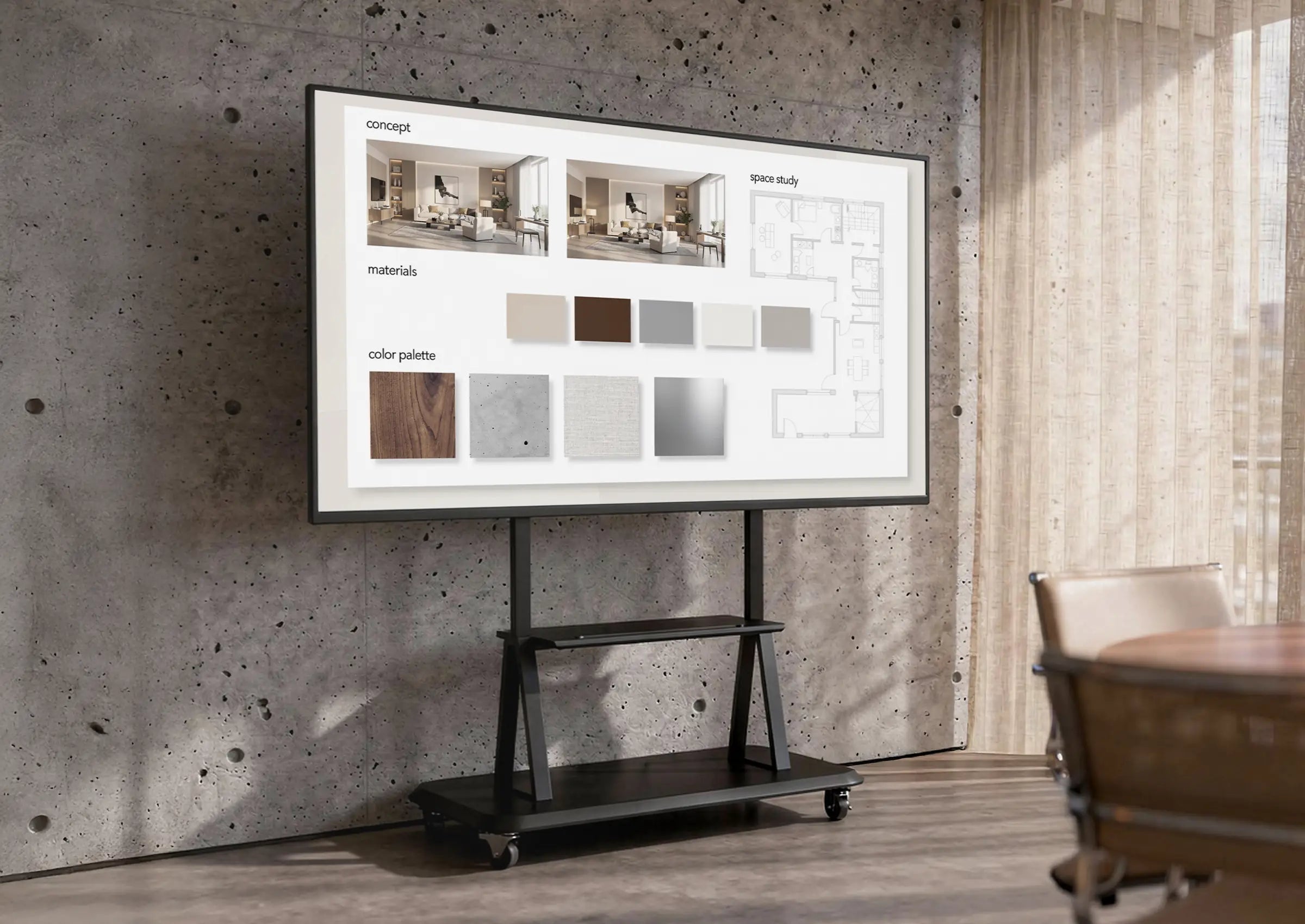 The image shows a modern meeting or creative workspace with a concrete wall and large windows with curtains. At the center stands a mobile presentation display on a celexon Professional height adjustable display trolley Adjust-55120MP, displaying a concept board with interior visualizations, material samples, and color palettes. The scene conveys a professional environment for architecture, design, or project meetings.